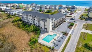 an aerial view of a building with a pool and the ocean at Unit 112D at Tiffany's in Surf City