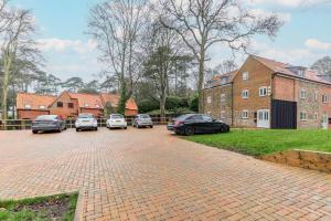 a group of cars parked in a parking lot at Number Five Hardwood Knoll House in Cromer