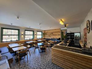 a restaurant with tables and chairs in a room at Pension Jitřenka Hřensko in Hřensko