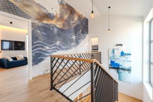 a staircase in a living room with a painting on the wall at Luxury Villa Kaia - Sea View, Heated pool, Jacuzzi, Gym and Sauna in Vodice