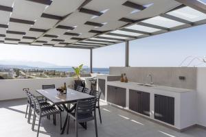 a kitchen and dining room with a table and chairs at Villa Aelia - With Private Pool & Sauna in Pigi