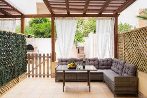 a patio with a couch and a table at Appartamenti Leone in San Vito lo Capo