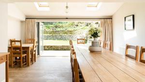 a kitchen and dining room with a table and a dining room at Lapwing Barns in Longnor