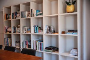 a library with white shelves filled with books at The Grand Hotel Robertson in Robertson