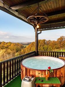 a hot tub on the balcony of a house at San Vinogradara in Donja Stubica