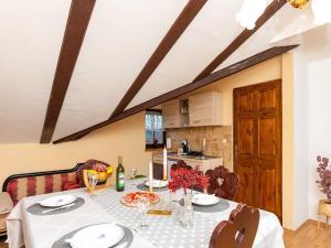 a dining room table with a white tablecloth on it at San Vinogradara in Donja Stubica