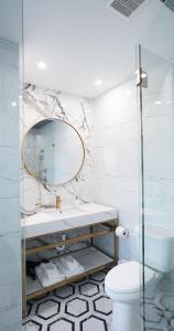 a bathroom with a sink and a mirror at Ivory Sands Beach Suites in Clearwater Beach