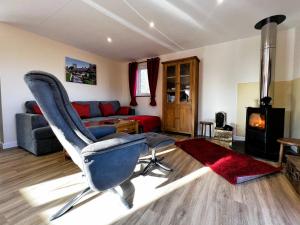 a living room with a chair and a couch at Cherry Lodge in Godshill