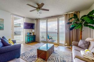 a living room with a couch and a ceiling fan at Majestic Beach Resort Tower 1 #915 in Panama City Beach