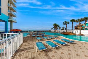 a swimming pool with lounge chairs and a resort at Majestic Beach Resort Tower 1 #915 in Panama City Beach