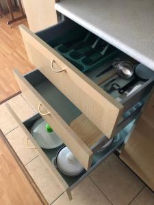 a drawer in a kitchen with dishes in it at Hotel Esplanade & Aparthotel Rialto in Binz