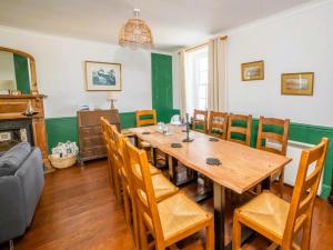 a dining room with a wooden table and chairs at Coastguard Cottage in Ventnor