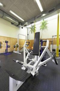 a room with a gym with a chair and machines at INDOOR Camping Sportzentrum Zeltweg in Zeltweg