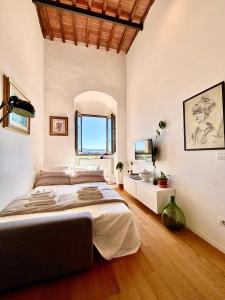 a bedroom with a large bed and a mirror at La Torre di Canonica in Colle di Val d'Elsa