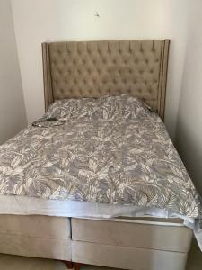 a bed in a room with a bed frame at Apartment with three Rooms in Prijevor
