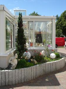a garden in front of a house with stuffed animals at Hotel Esplanade & Aparthotel Rialto in Binz