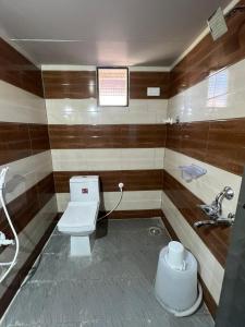 a bathroom with a toilet and a sink at Hippie Land Nature Stay in Hampi