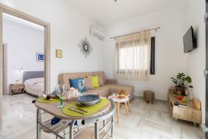 a living room with a table and a couch at L&D Apartment in Neos Marmaras