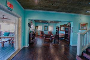 a living room with blue walls and a table and chairs at A Stone's Throw Away in Nassau