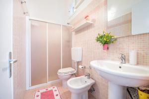 a bathroom with a toilet and a sink at La Dimora Lucia by Paf in tour in Torre Suda +11 photos