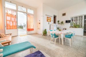 a living room with a table and chairs at La Dimora Lucia by Paf in tour in Torre Suda