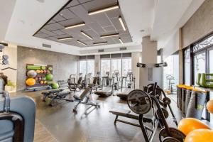 a gym with several treadmills and exercise bikes at The Capital On the Park Self-Catering Apartments in Johannesburg