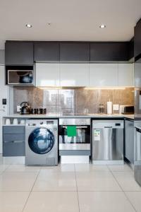 a kitchen with a washing machine and a dishwasher at The Capital On the Park Self-Catering Apartments in Johannesburg