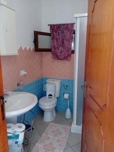 a bathroom with a toilet and a sink at Casa Terme Romane in Castelsardo