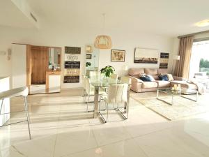 a living room with a couch and a table at Noctua Estepona Luxury Apartment Belair 005 in Estepona