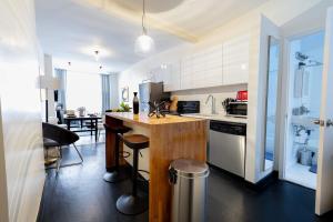 a kitchen with a counter and a dining room at E10-1 Designer East Village Townhouse 1BR in New York
