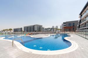 a large swimming pool in the middle of a building at TAMM HOMES-SAMANA GOLF AVENUE in Dubai