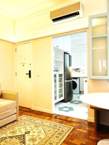 uma sala de estar com um frigorífico numa cozinha em Incrível Apartamento na Quadra da Praia no Rio de Janeiro