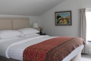 a bedroom with a bed and a picture on the wall at Hen Ffermdy in Jordanston