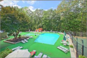 a swimming pool with lounge chairs and a playground at Emerald City Lights #203 in Gatlinburg