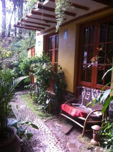 a bench sitting outside of a house at Wayras Hostal in Ollantaytambo