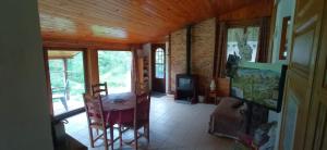 a living room with a table and a fireplace at Gite à la Ferme in Arrodets-ez-Angles