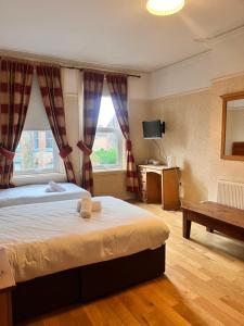 a bedroom with a large bed and a window at Beech Mount Grove Suites in Liverpool