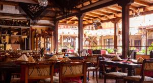 a restaurant with tables and chairs and a bar at Hotel La Posada de San Antonio in Villa de Leyva