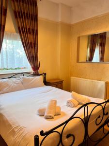 a bedroom with a bed with two towels on it at Beech Mount Grove Suites in Liverpool