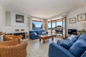 sala de estar con sofás azules y TV en Llenaire 1, sea view, pool, wifi, en Puerto Pollensa