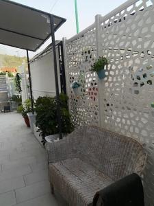 a patio with a bench and a fence with plants at Case Vacanza Da Silvì in Agropoli