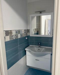 a bathroom with a sink and a mirror at Case Vacanza Da Silvì in Agropoli +12 photos