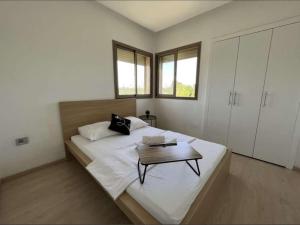 a bedroom with a large bed with a table on it at Prestigia Golf entrée Agate (wifi) in Marrakesh