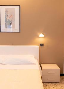 a bedroom with a bed and a picture on the wall at Hotel Galileo in Rimini