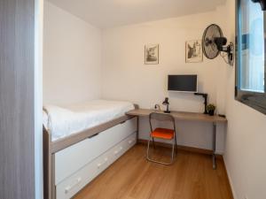 a small bedroom with a desk and a bed at BHost - María Auxiliadora in Córdoba