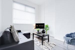 a living room with a couch and a table at Beautiful Apartment tres in Litherland