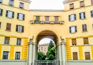 a yellow building with an arch in front of it at Holiday Home i Cervi in Rome