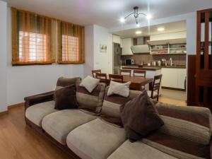 a living room with a couch and a kitchen at BHost - María Auxiliadora in Córdoba +44 photos
