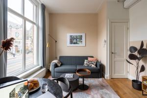 a living room with a couch and a window at Yays Amsterdam Vondelpark by Numa in Amsterdam