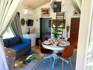 ein kleines Wohnzimmer mit einem Tisch und Stühlen in der Unterkunft Cosy cottage by the south coast in Trelleborg